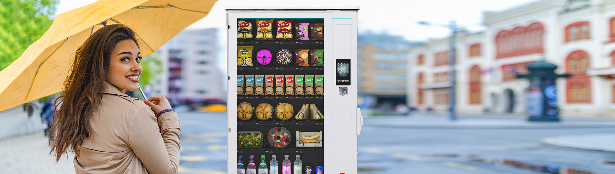 Frau mit gelbem Regenschirm vor einem Sielaff-Automaten aus der SiLine Outdoor-Serie